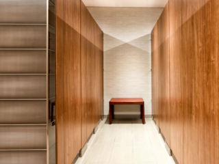 High privacy business bathroom with full height compartments and zero sightline present a clean look in attractive, brown laminate.