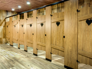 Custom shape bathroom partitions with heart shape engraving on brown, outhouse look laminate doors with powder coat hardware.