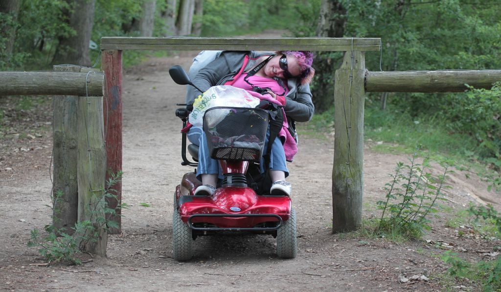 Wheelchair occupant maneuvering through an obstacle.