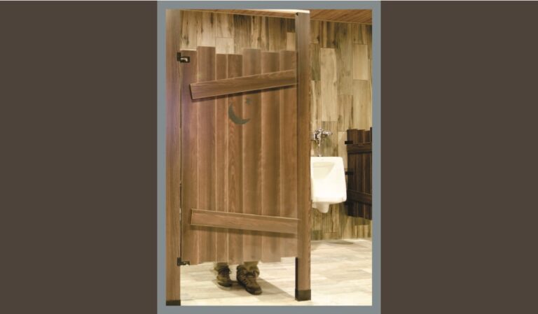Rustic toilet partition emphasizing floor gap.