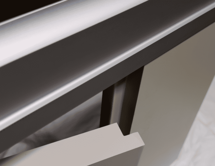 A close-up view of a partially open beige drawer with a silver metal countertop surface above it, offering a sleek privacy solution.