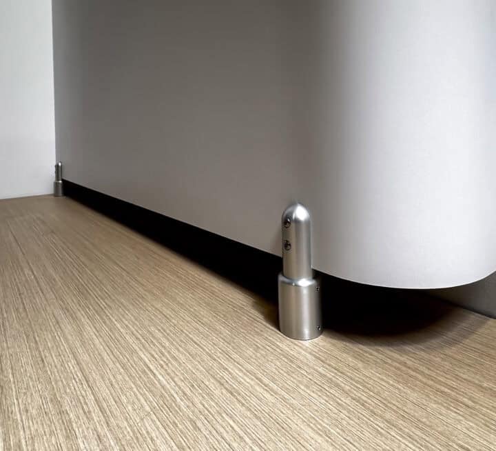 Custom shape commercial restroom with rounded corners and aluminum pedestal supports.