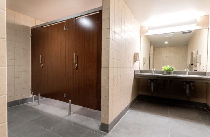 Public restroom with European mounting (headrail and pedestals) and flat slap doors in plastic laminate.