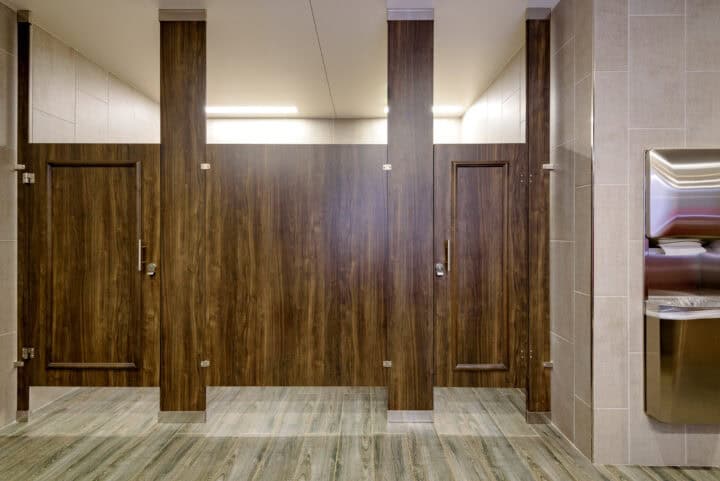 Floor to ceiling woodgrain high pressure laminate toilet partitions with zero sightline