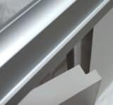 Close-up view of Ironwood Manufacturing’s Zero Sightline toilet partition hardware showing interlocking door and pilaster components with clean matte finishes